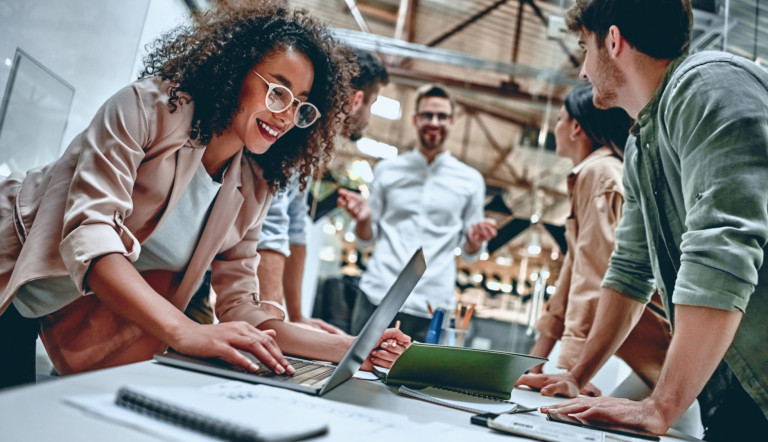 Group of young multiracial business people are working in modern office. Freelancers in coworking place. Creative and stylish youth. Young business people in office