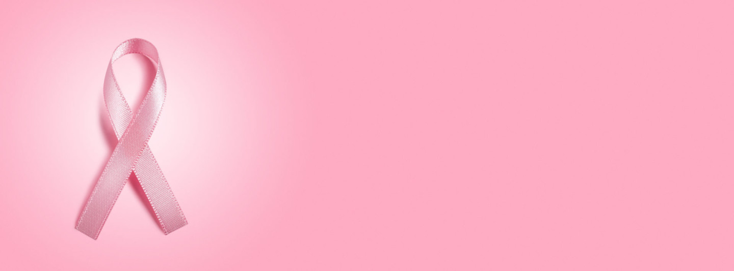 pink ribbon on pink background with copy space