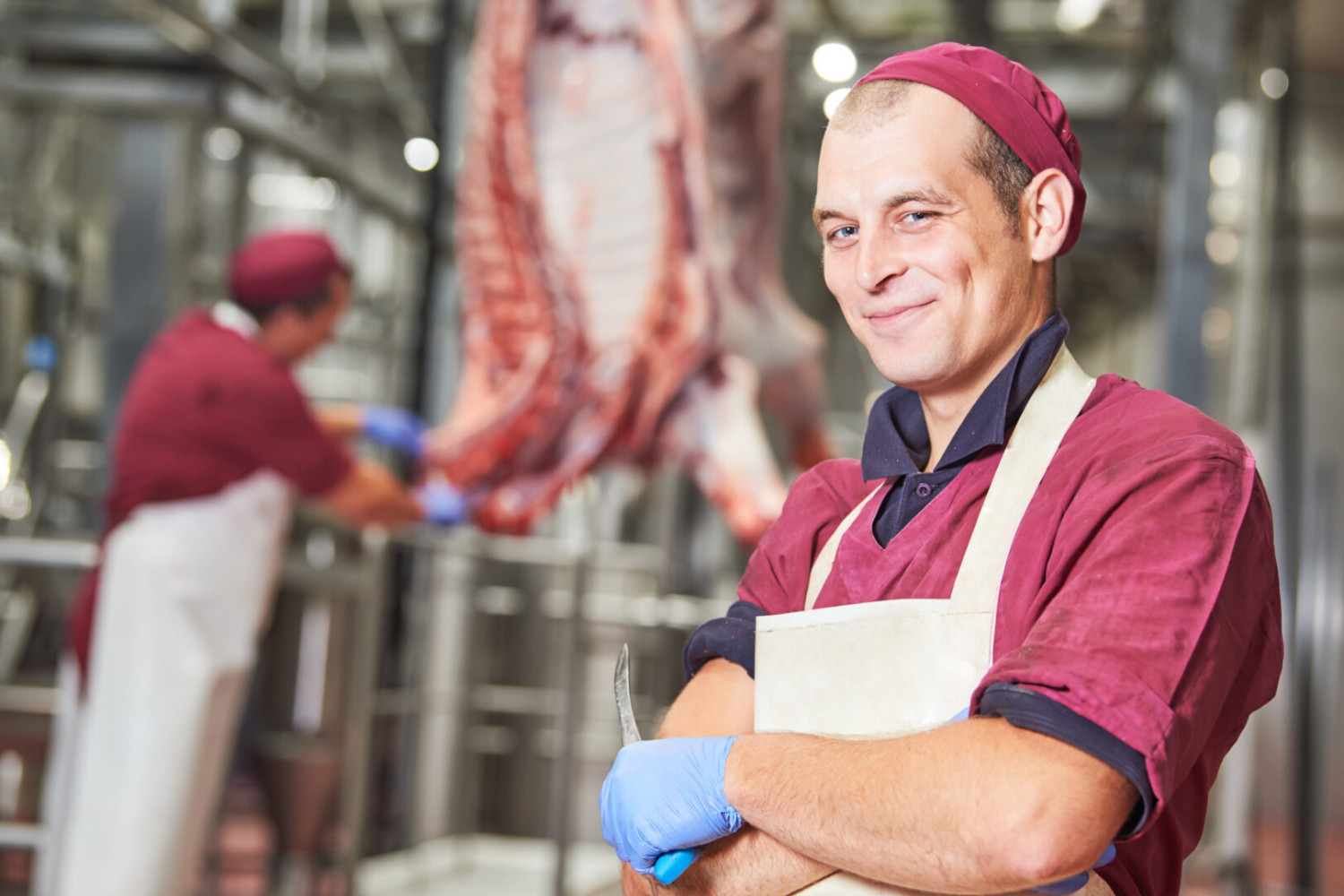 meat manufacturing factory. Portrait of young butcher
